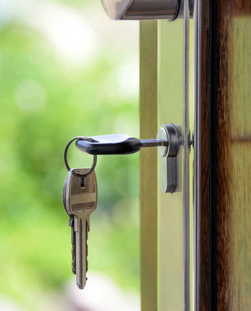 Keys opening front door of a home