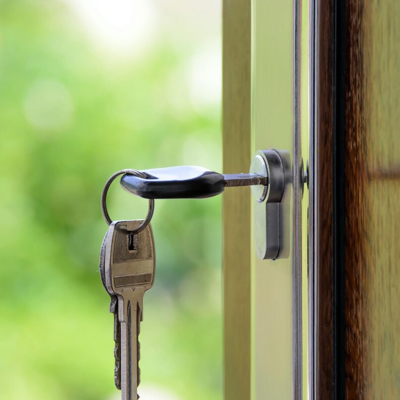 Keys opening front door of a home